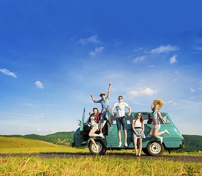 A group posing beside a camper van